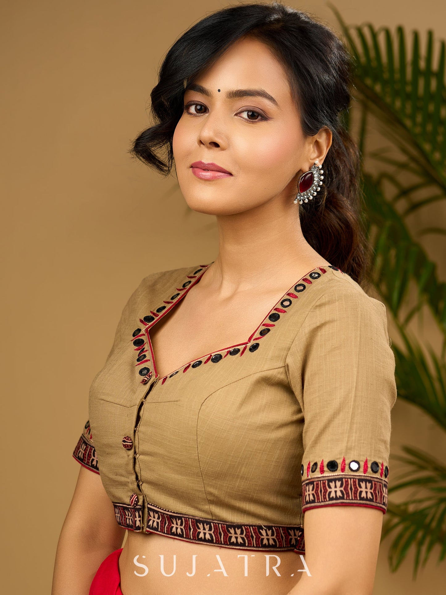 Exquisite hand embroidered dark beige ajrakh combination cotton blouse.
