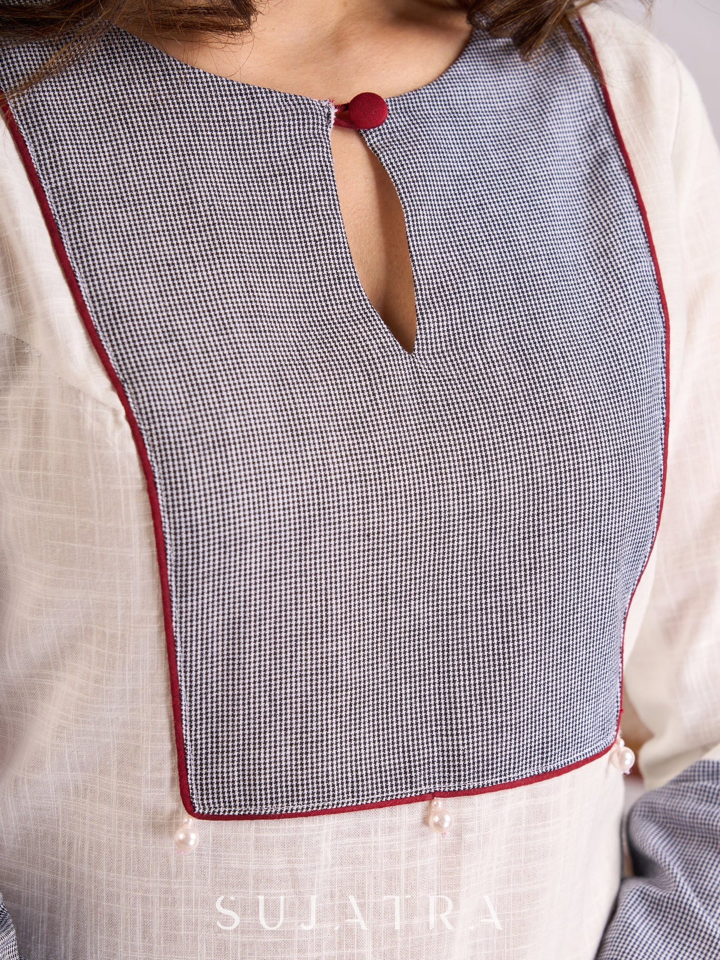 Graceful White Cotton Kurta with Checkered Yoke & Cuffs, Maroon Piping & Pearl Embellishments