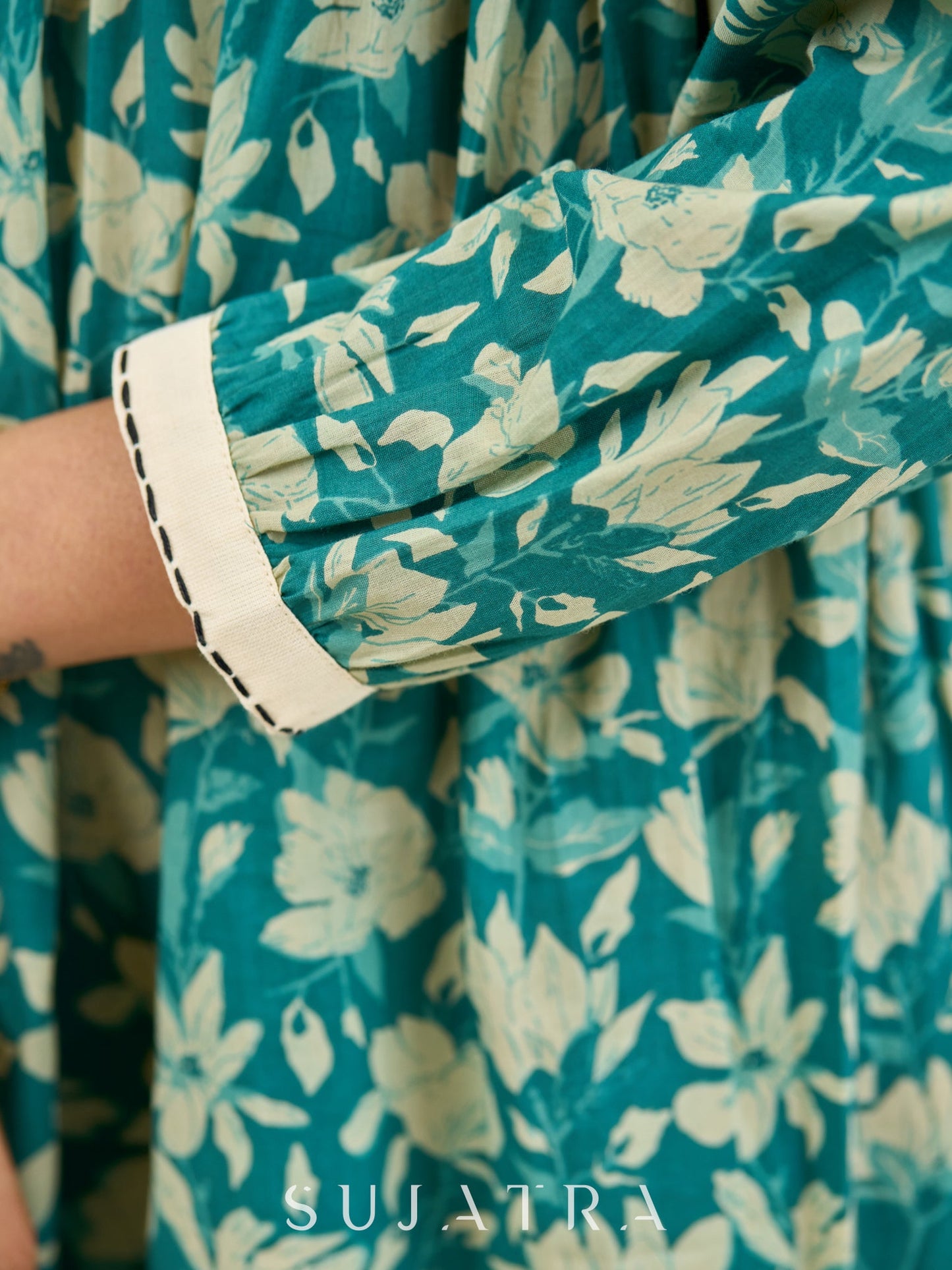 Artful Teal Floral Peplum Dress with Gathered Silhouette, Off-White Piping, and Intricate Black Kantha and French Knot Accents