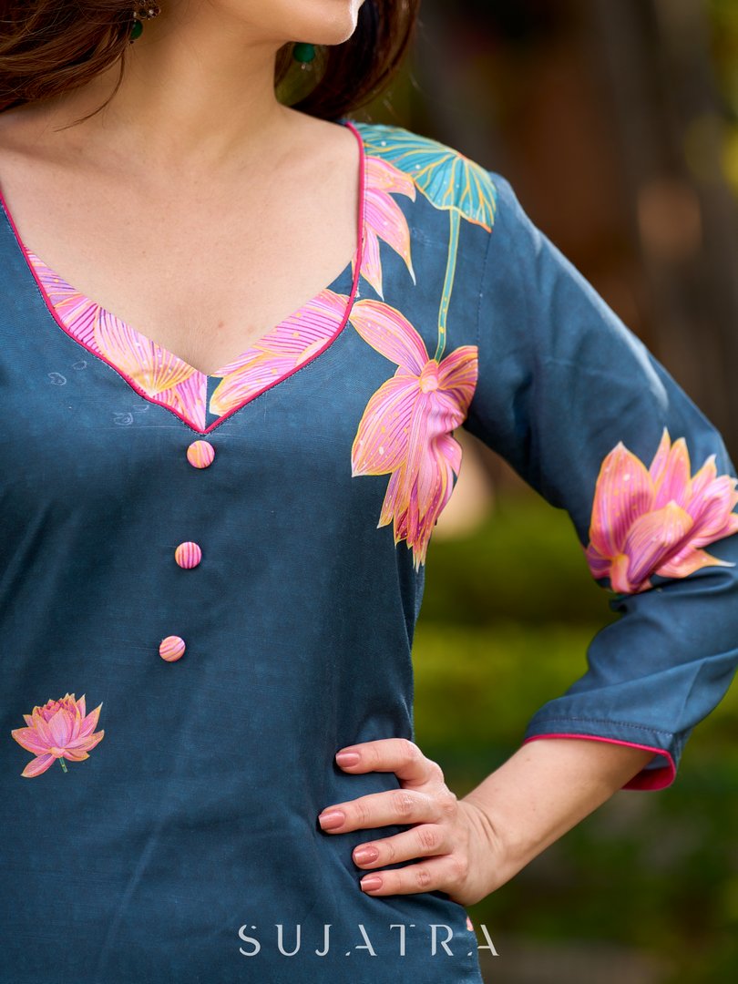 Graceful teal kurta with delicate pink lotus printing, subtle pink accents, and a statement patch above the neckline.