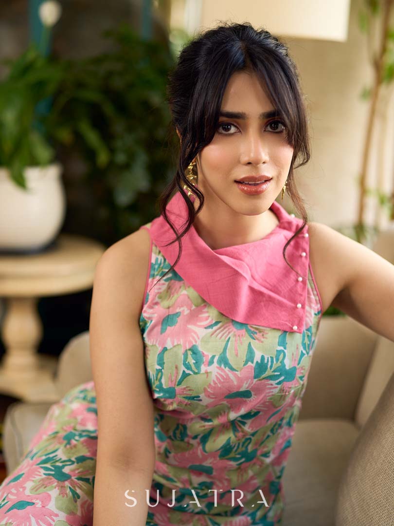 Summer pink floral sleeveless dress featuring an asymmetrical cowl collar and delicate pearl accents, creating a soft, fluid silhouette with a touch of elegant, contemporary charm.