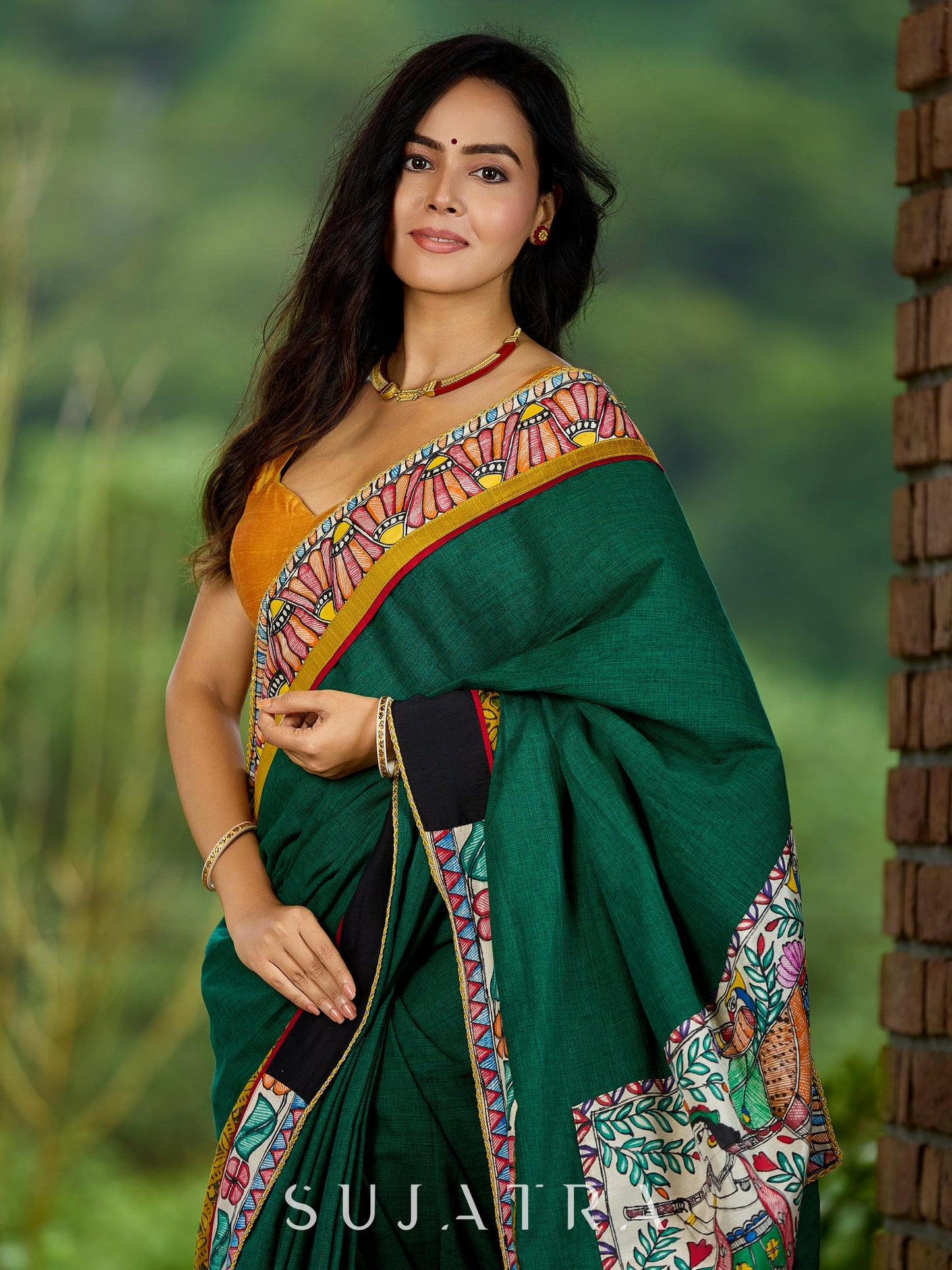 Artisanal cotton saree in bold green with Madhubani hand painted charm