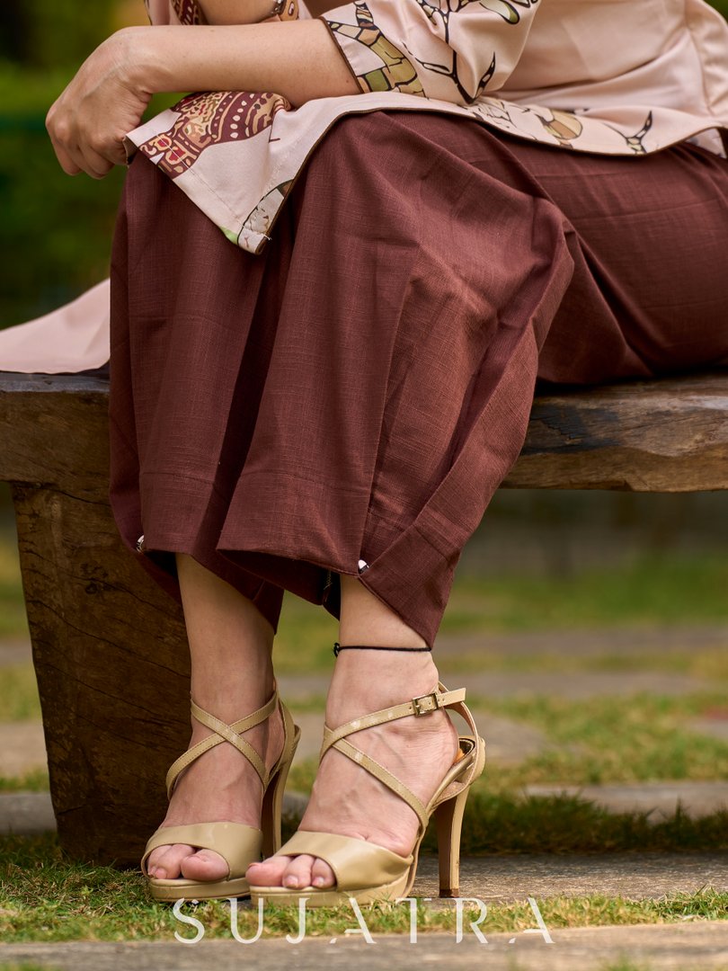 Artisanal cream kurta adorned with Gond-inspired motifs and classic brown accents