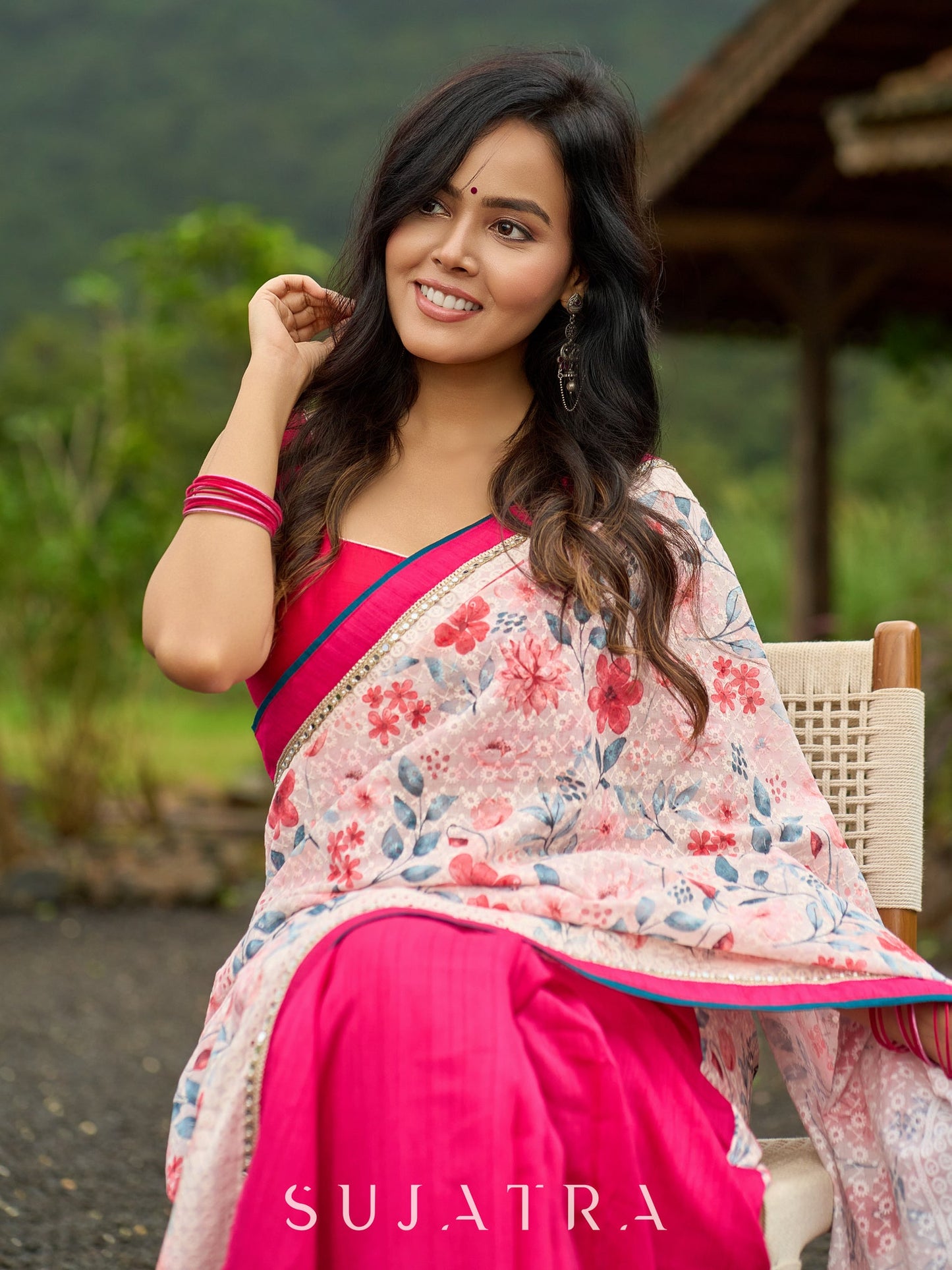 Floral-inspired white saree elevated with fuchsia pleats and borders