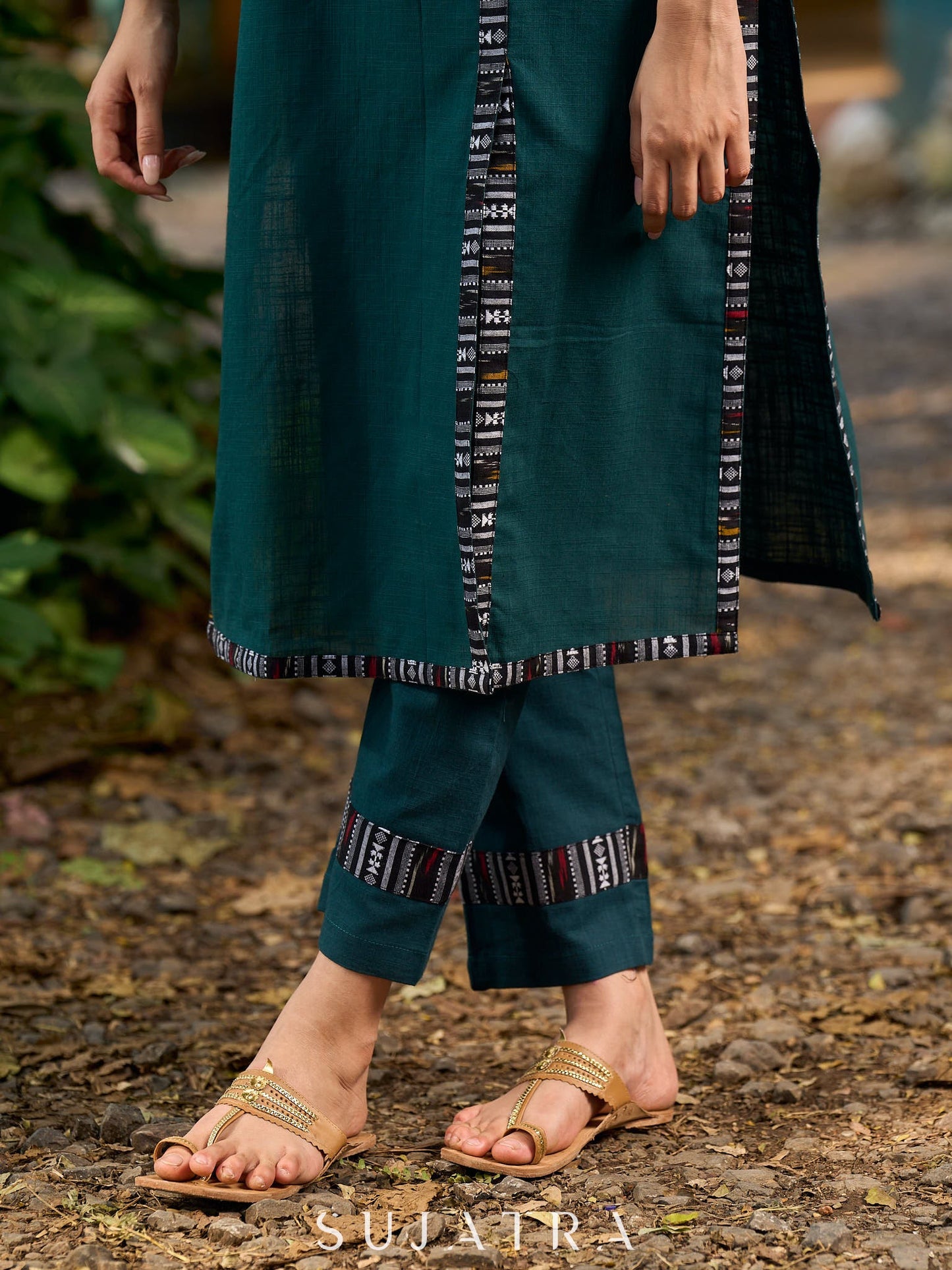 bottle green solid kurta with a refined ajrakh edging.