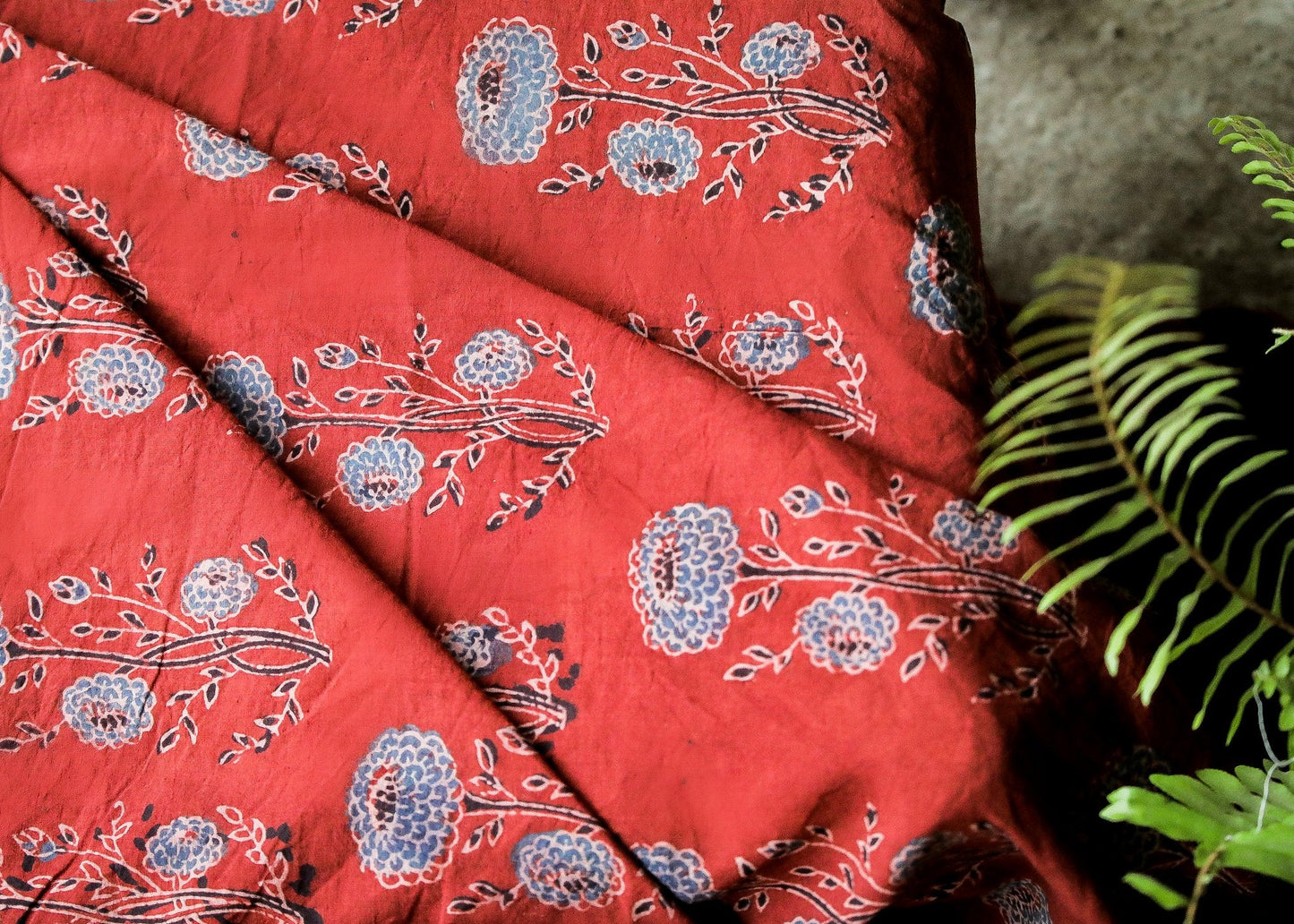 Block Printed Ajrakh Cotton Fabric with Blue Floral Motifs on Chilli Red Colour