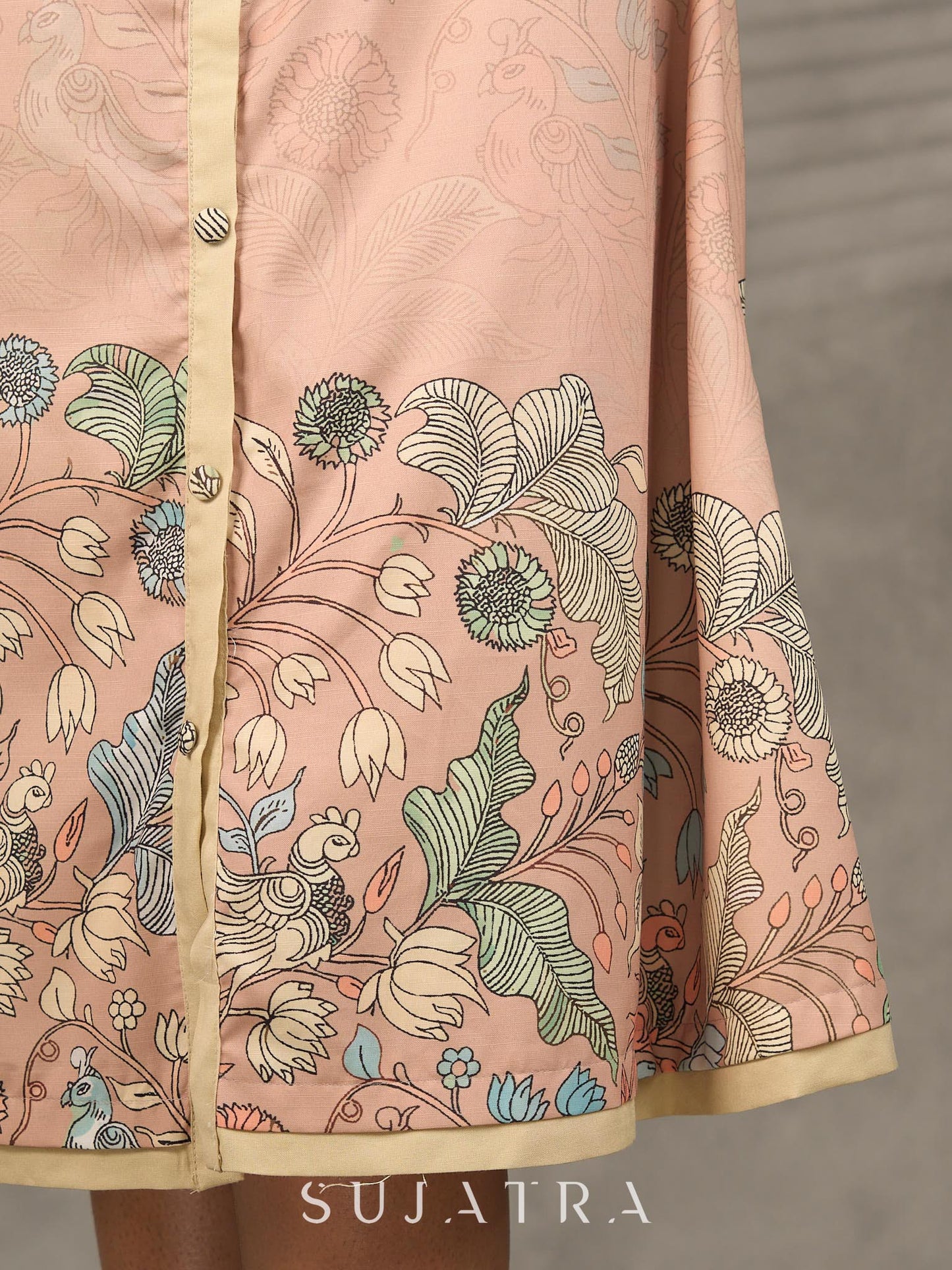 Peach Kalamkari-inspired shirt dress with soft beige accents.