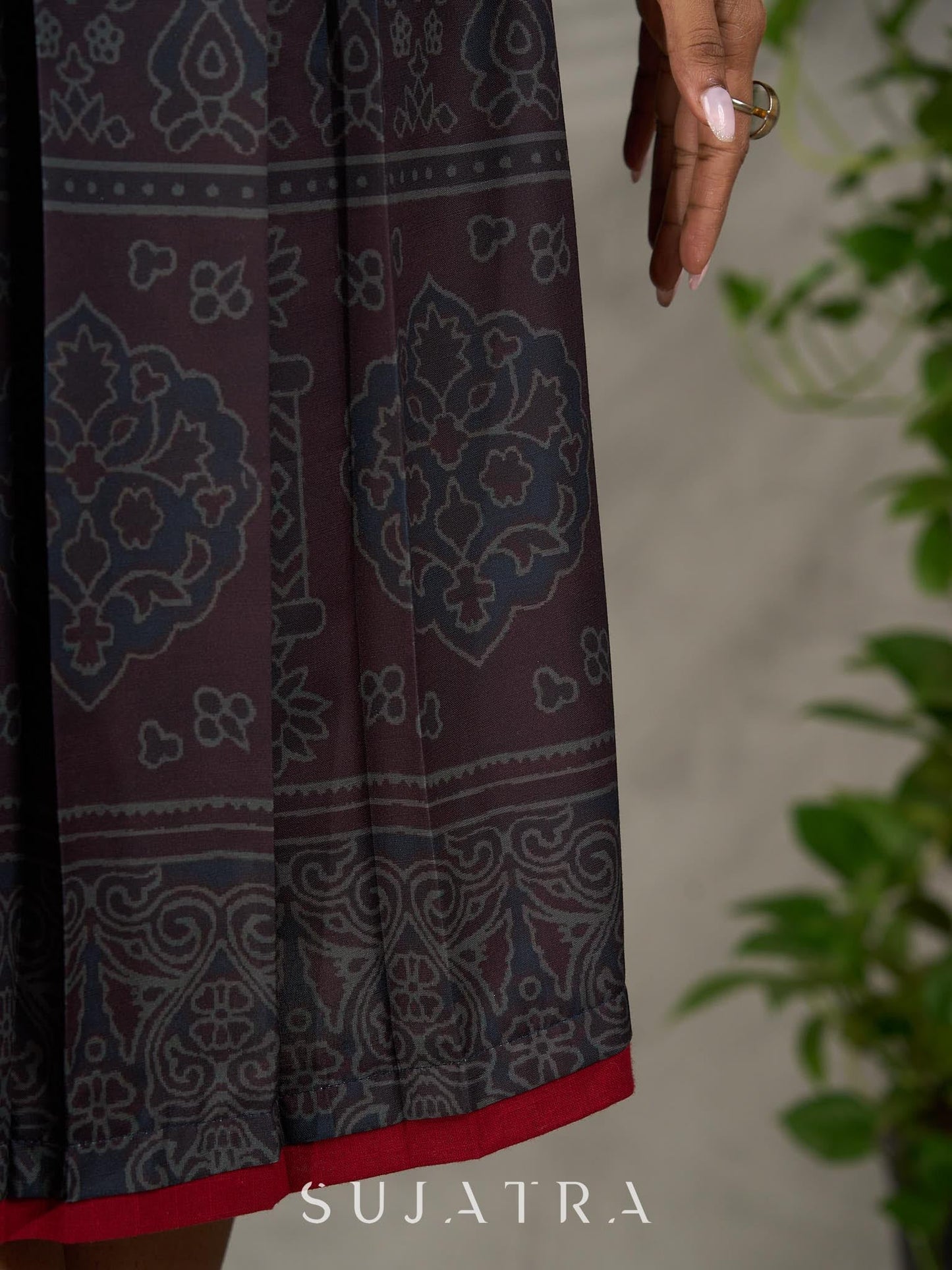 Black Ajrakh printed dress with pleats, maroon accents, and silver embellishments.