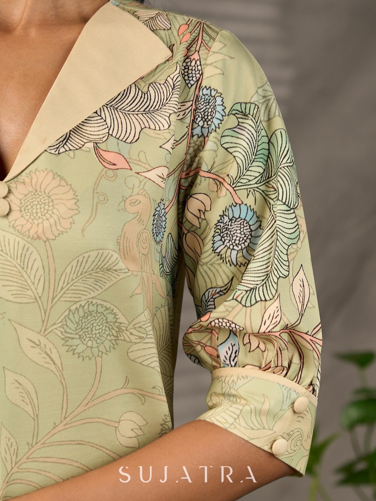 Soft green Kalamkari printed collared dress with centre pleat detailing.