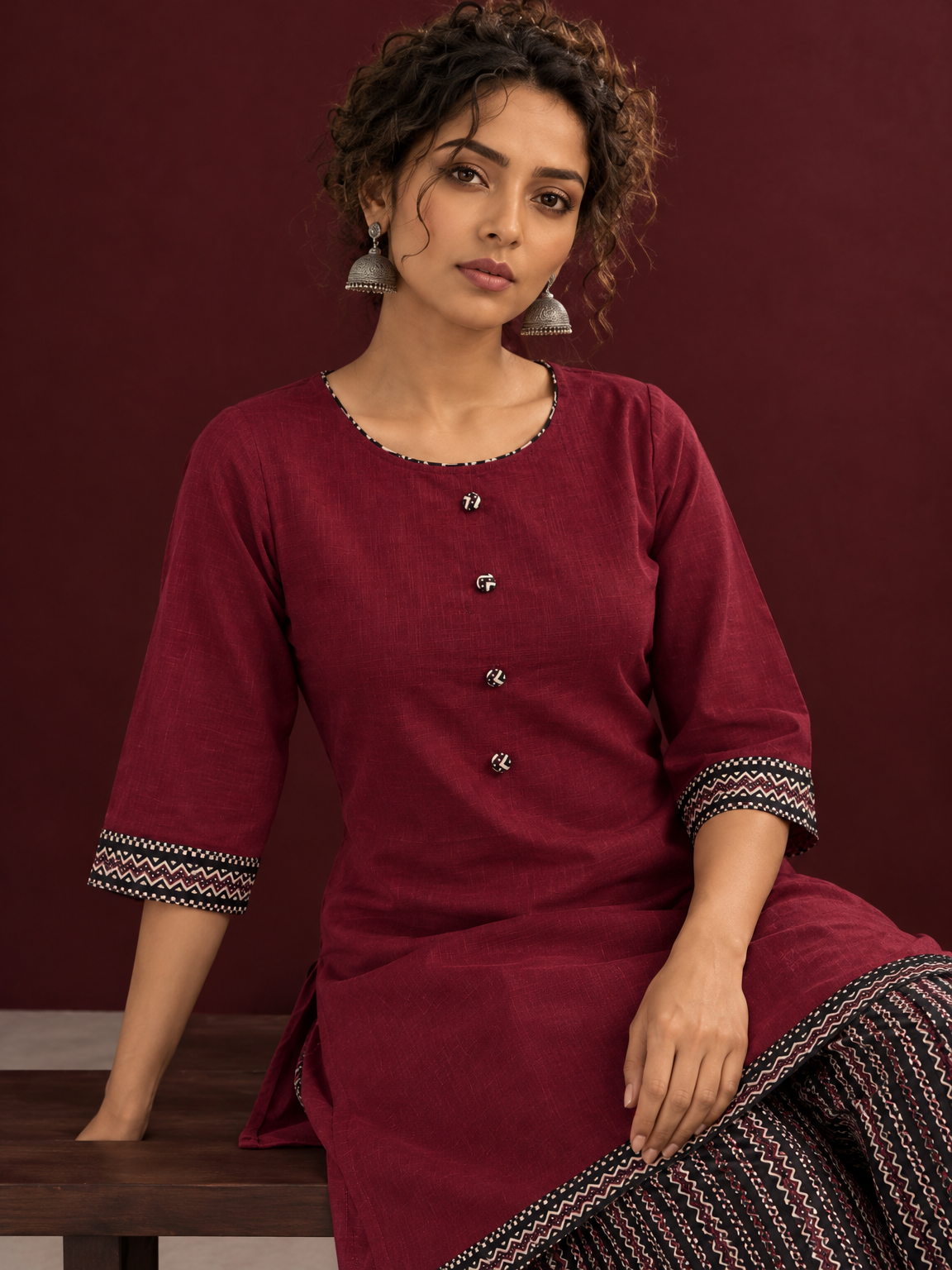 Timeless Maroon Ajrakh Cotton Co-Ord Set with Contrast Printed Border Tunic & Matching Geometric Pattern Fars — seated detail