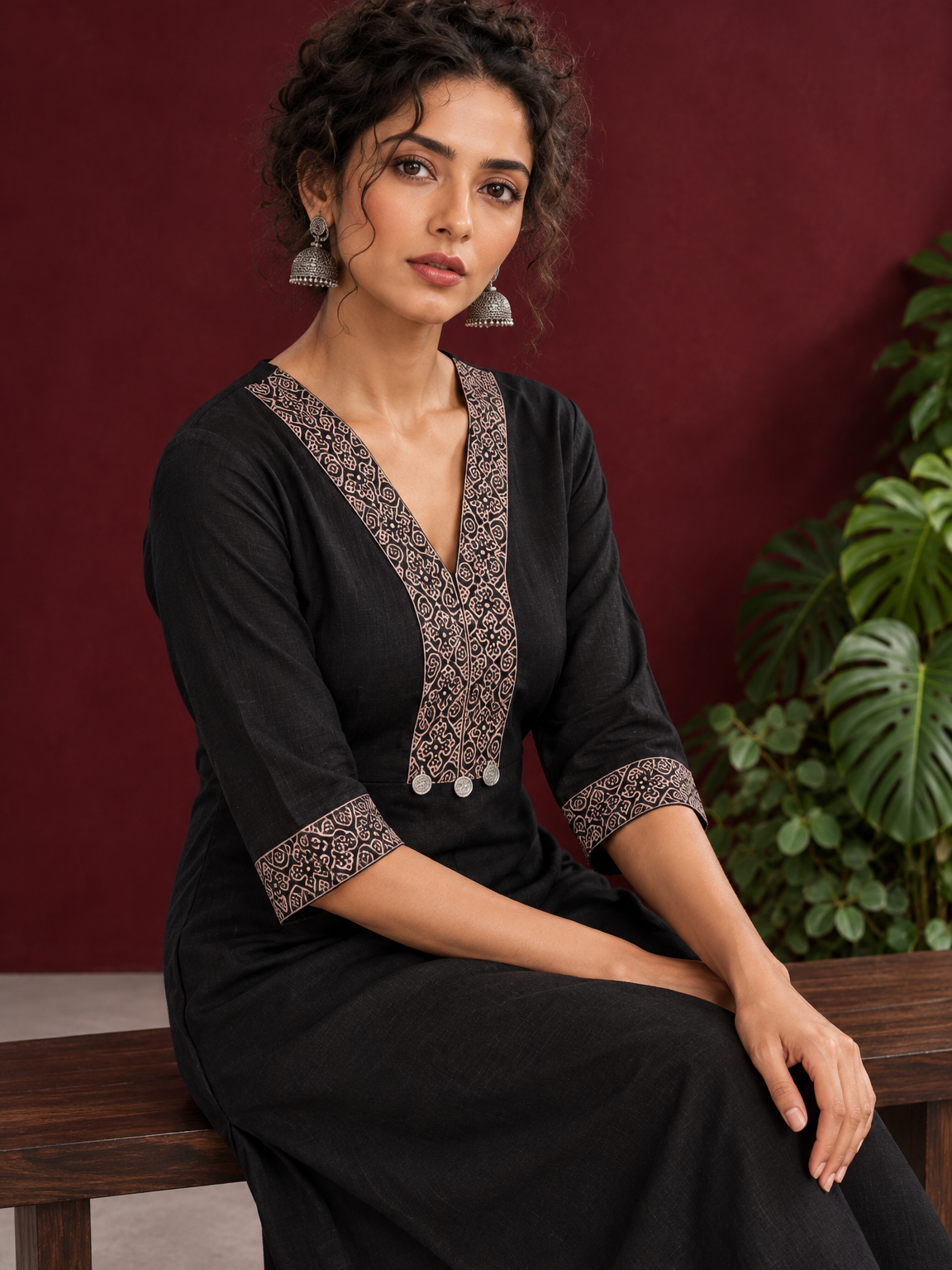 Timeless Black Cotton Kurta with Contrast Beige Ajrakh Printed V-Neck Panel & Matching Sleeve Cuffs — seated detail
