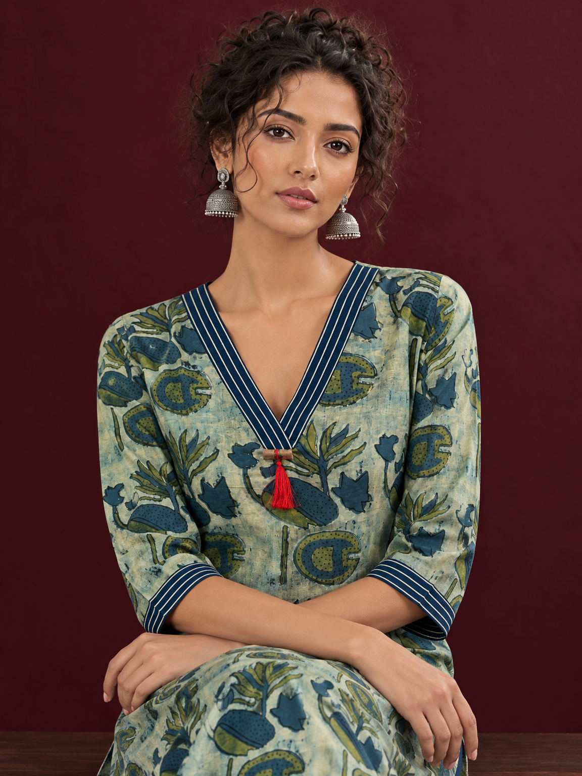 Sage Green Cotton Kurta with Hand Block Printed Floral Motifs and Contrast Navy Striped V-Neck — seated detail