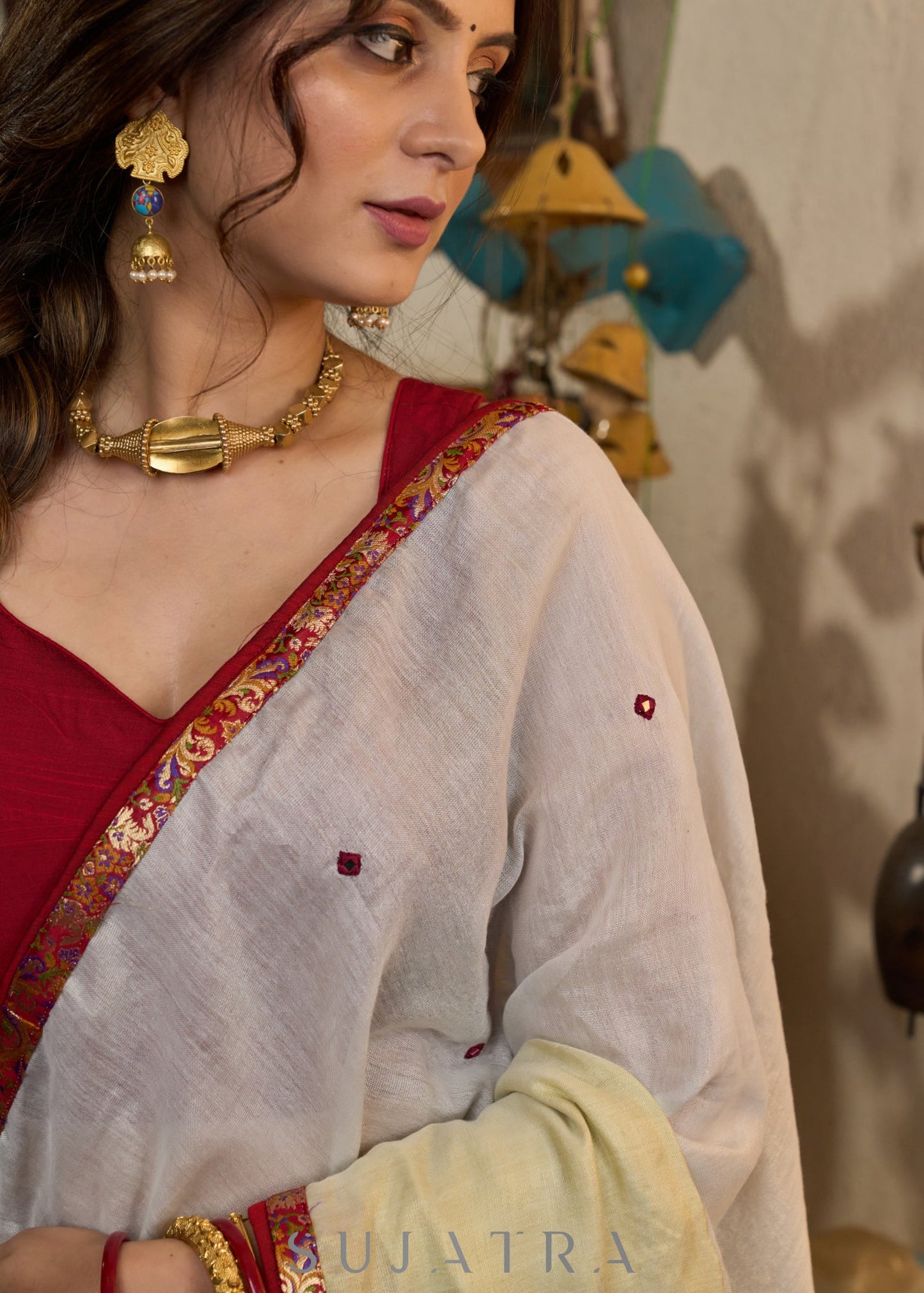 Elegant silver & golden linen half and half saree highlighted with contrast mirror work