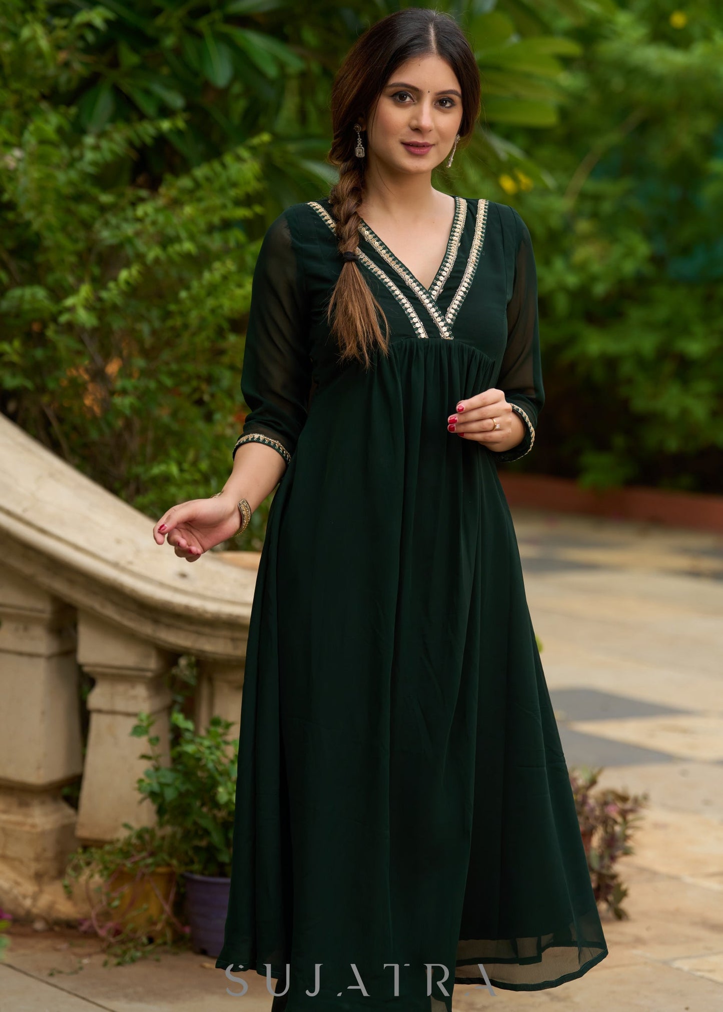 Elegance redefined in this captivating green georgette lace kurta and pant ensemble