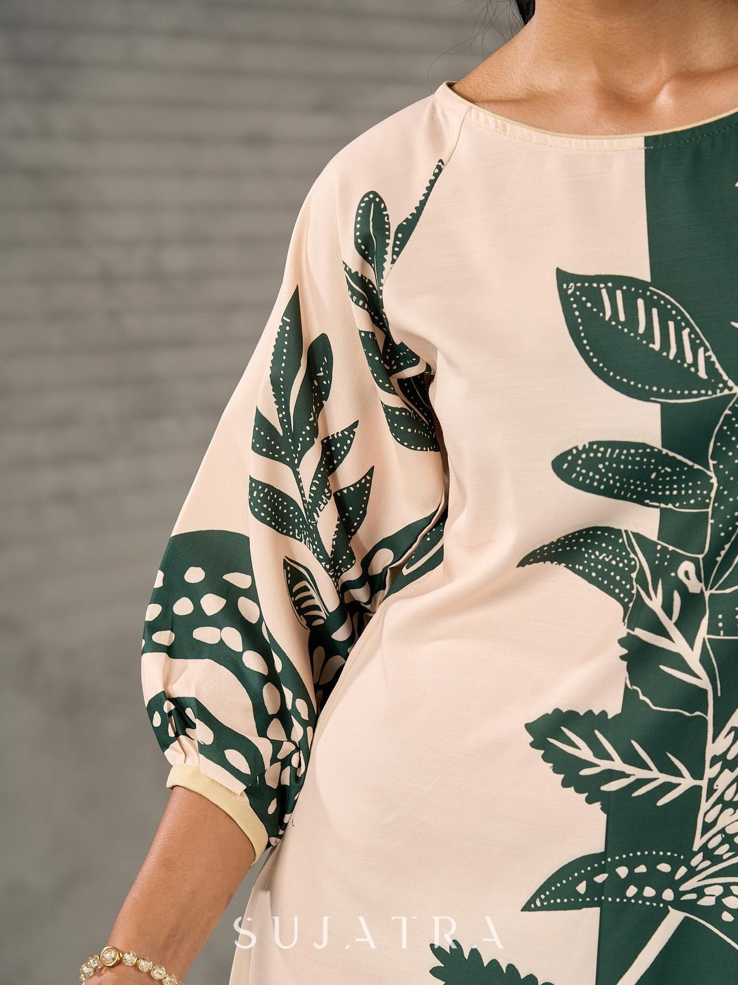 Bottle green and beige half and half dress with raglan sleeves and transitioning floral motifs.