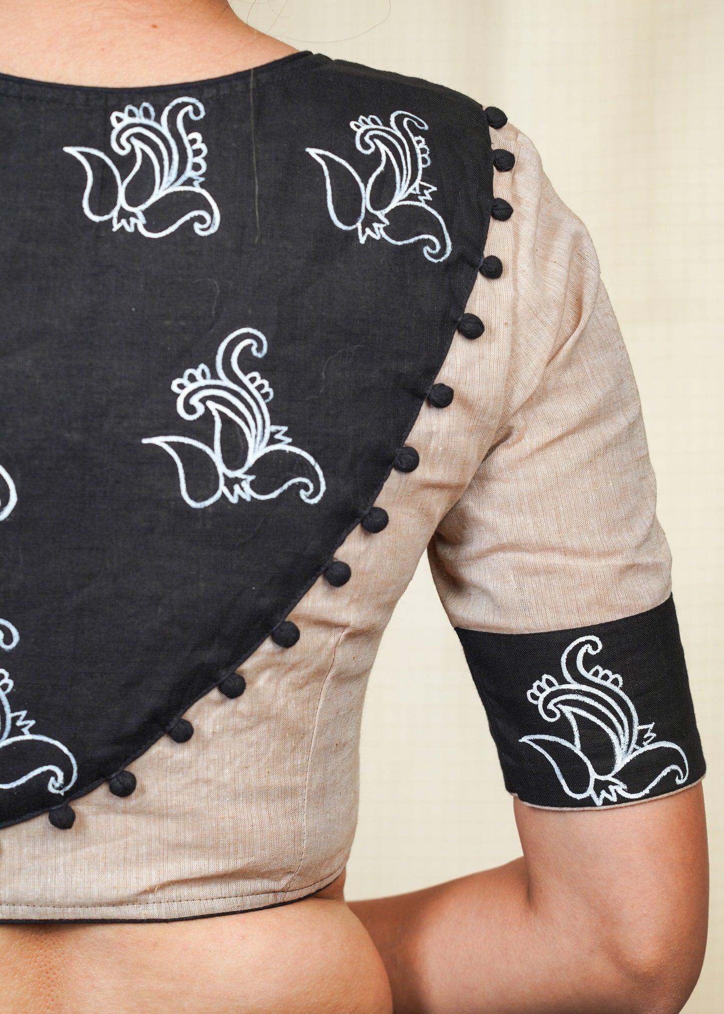 Beige Handloom Cotton Blouse With Hand Painted Motifs at the Back and sleeves and potli work