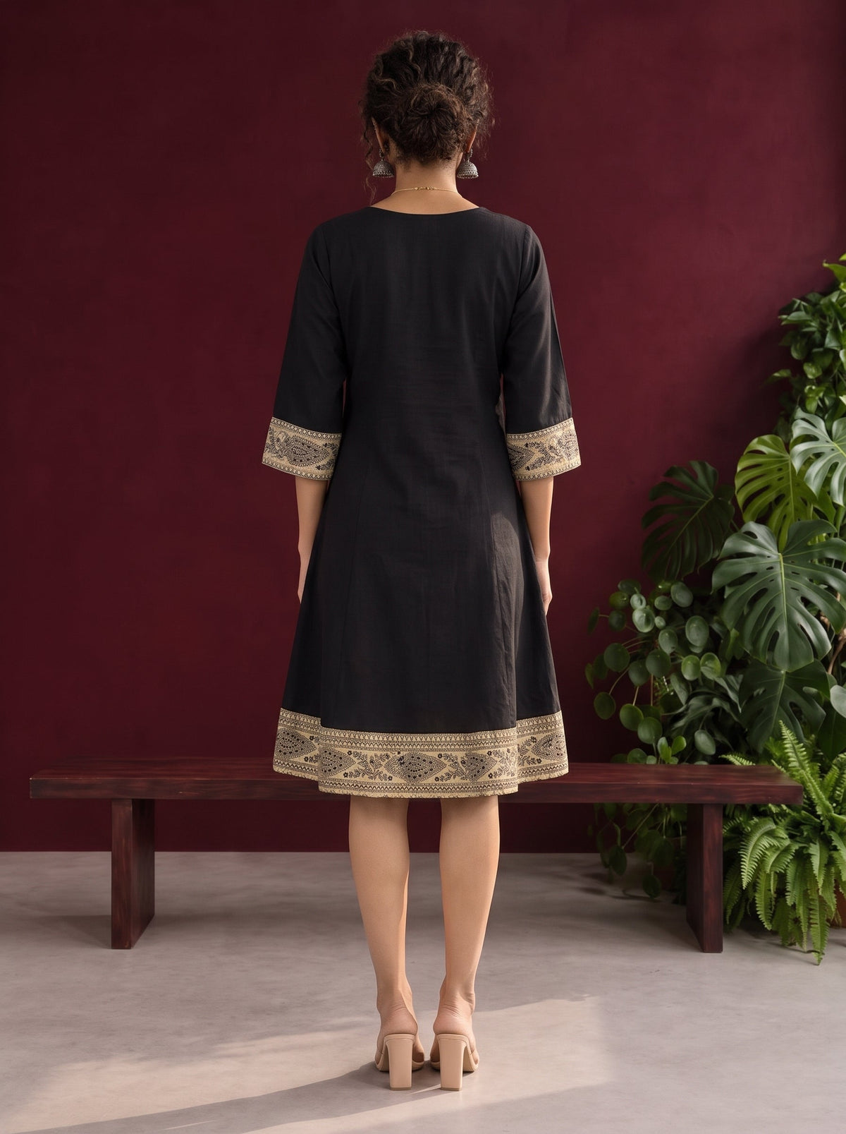 Elegant Black Cotton A-Line Dress with Madhubani Print Border Hem and Matching Bell Sleeve Cuffs — back view