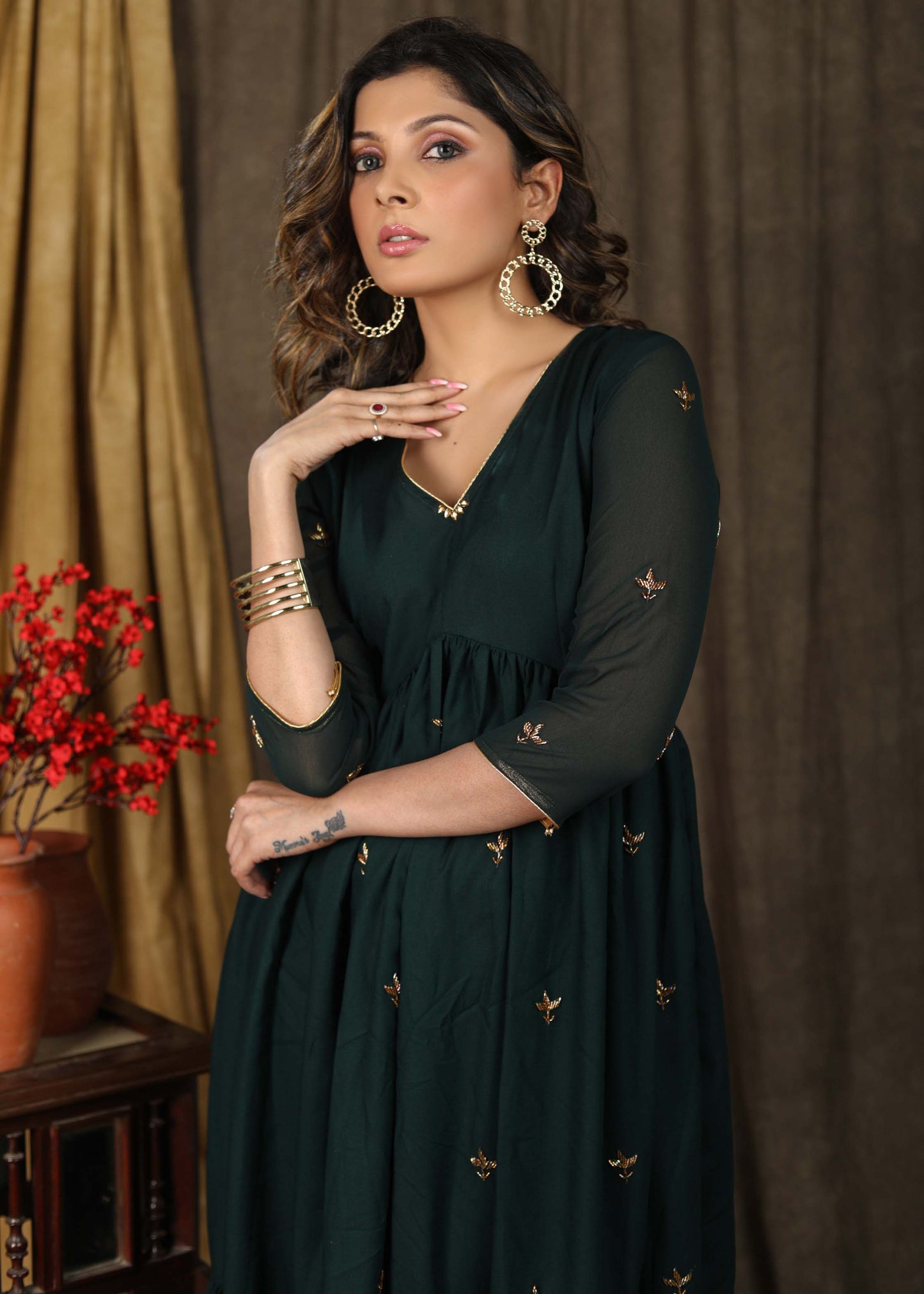 Beautiful bottle green gathered dress with minimal hand embroidery and georgette hemline