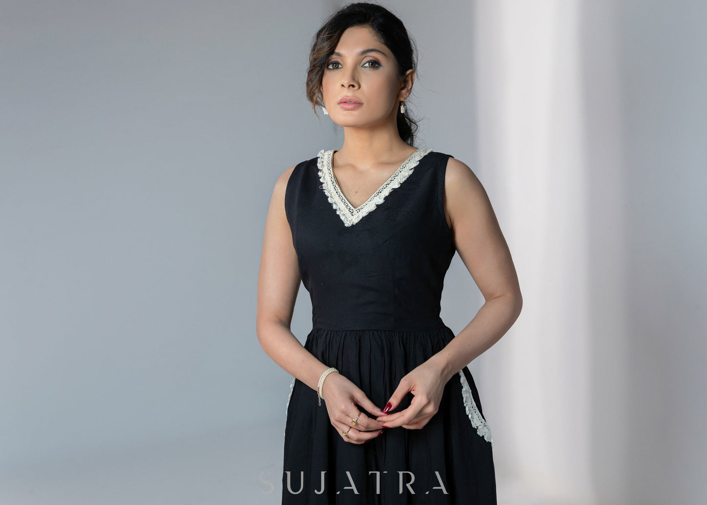 Black sleeveless rayon dress with off white lace detailing on neck and pockets