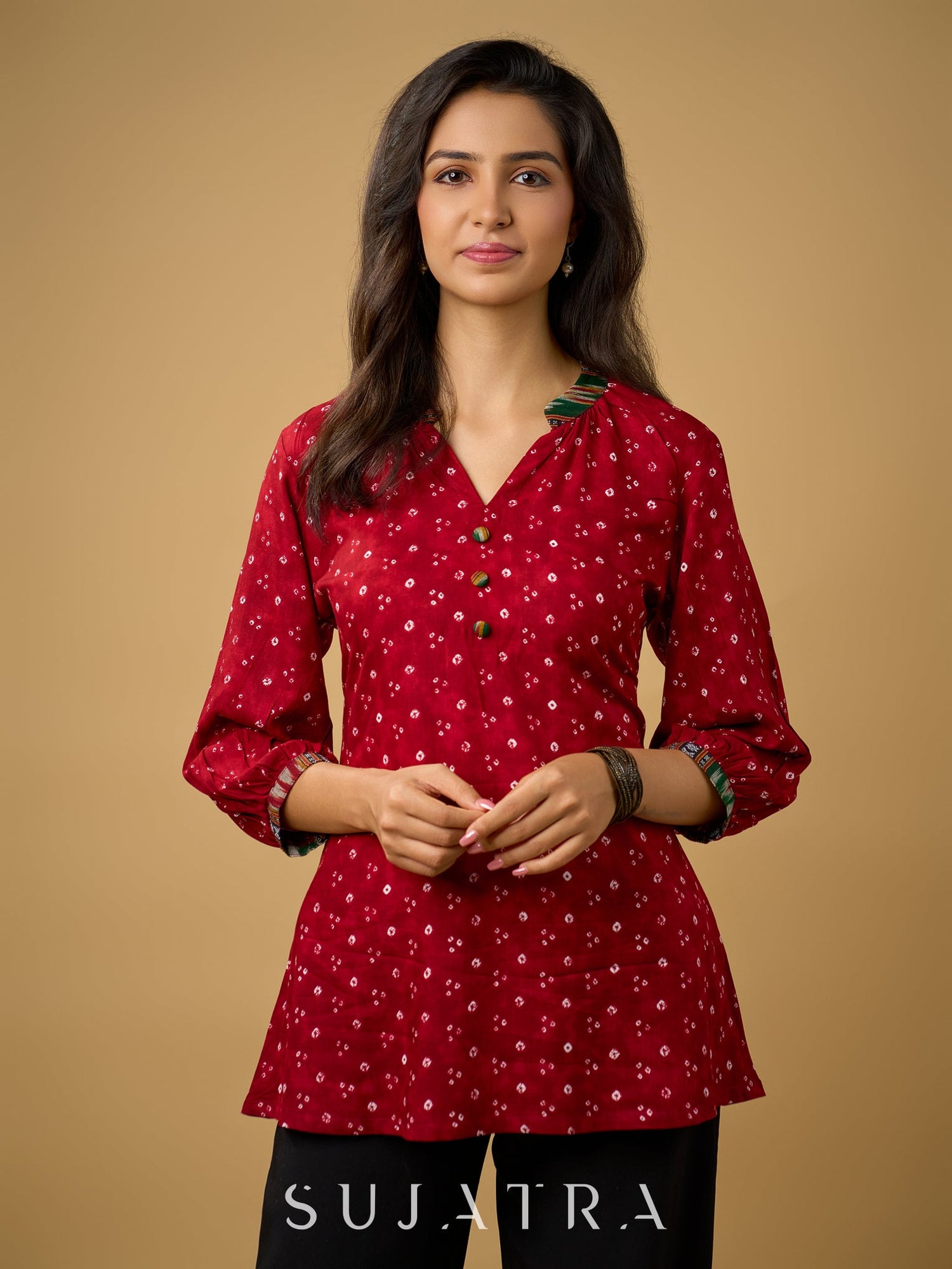 Red rayon bandhani top beautifully combined with classic ikat collar.