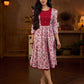 Elegant white floral Jaipuri printed dress with a delicately pintucked red panel, gathered sleeves, and rich red accents.