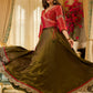 Luminous Green tissue lehenga with a classic Red Angrakha choli featuring intricate hand embroidery.