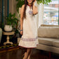 Off-white dress featuring intricate Madhubani artwork and a maroon Mandarin collar.