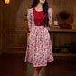 Elegant white floral Jaipuri printed dress with a delicately pintucked red panel, gathered sleeves, and rich red accents.