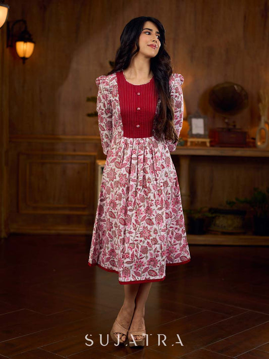 Elegant white floral Jaipuri printed dress with a delicately pintucked red panel, gathered sleeves, and rich red accents.