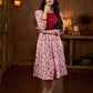 Elegant white floral Jaipuri printed dress with a delicately pintucked red panel, gathered sleeves, and rich red accents.
