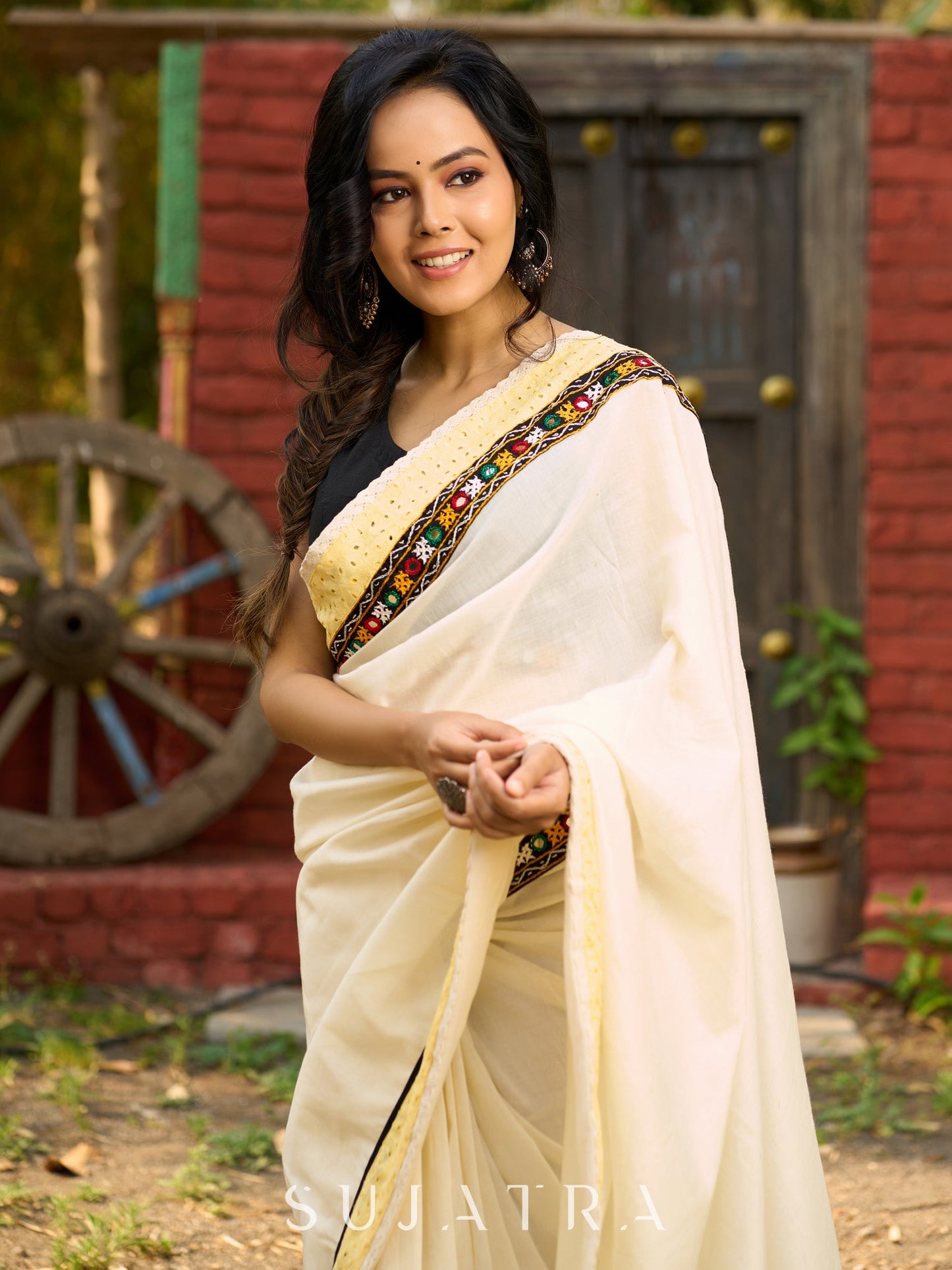 Exclusive off white mul saree with yellow hakoba border paired with Kutch mirror work border
