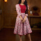 Elegant white floral Jaipuri printed dress with a delicately pintucked red panel, gathered sleeves, and rich red accents.
