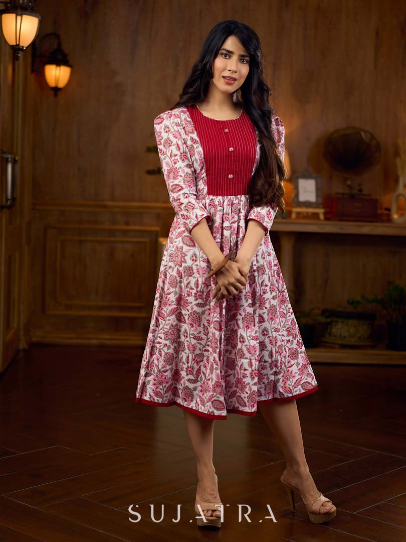 Elegant white floral Jaipuri printed dress with a delicately pintucked red panel, gathered sleeves, and rich red accents.