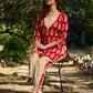 Vibrant red viscose short kurta showcasing a charming floral print, refined pintuck neck panel