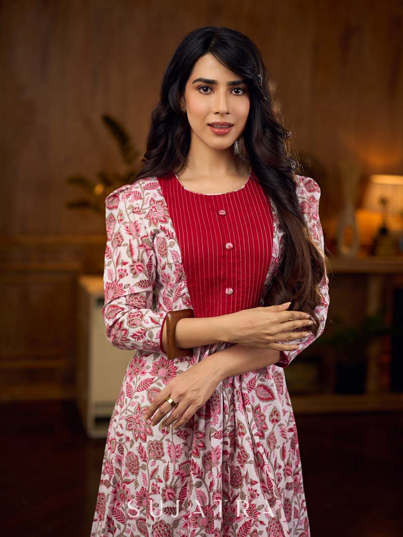 Elegant white floral Jaipuri printed dress with a delicately pintucked red panel, gathered sleeves, and rich red accents.