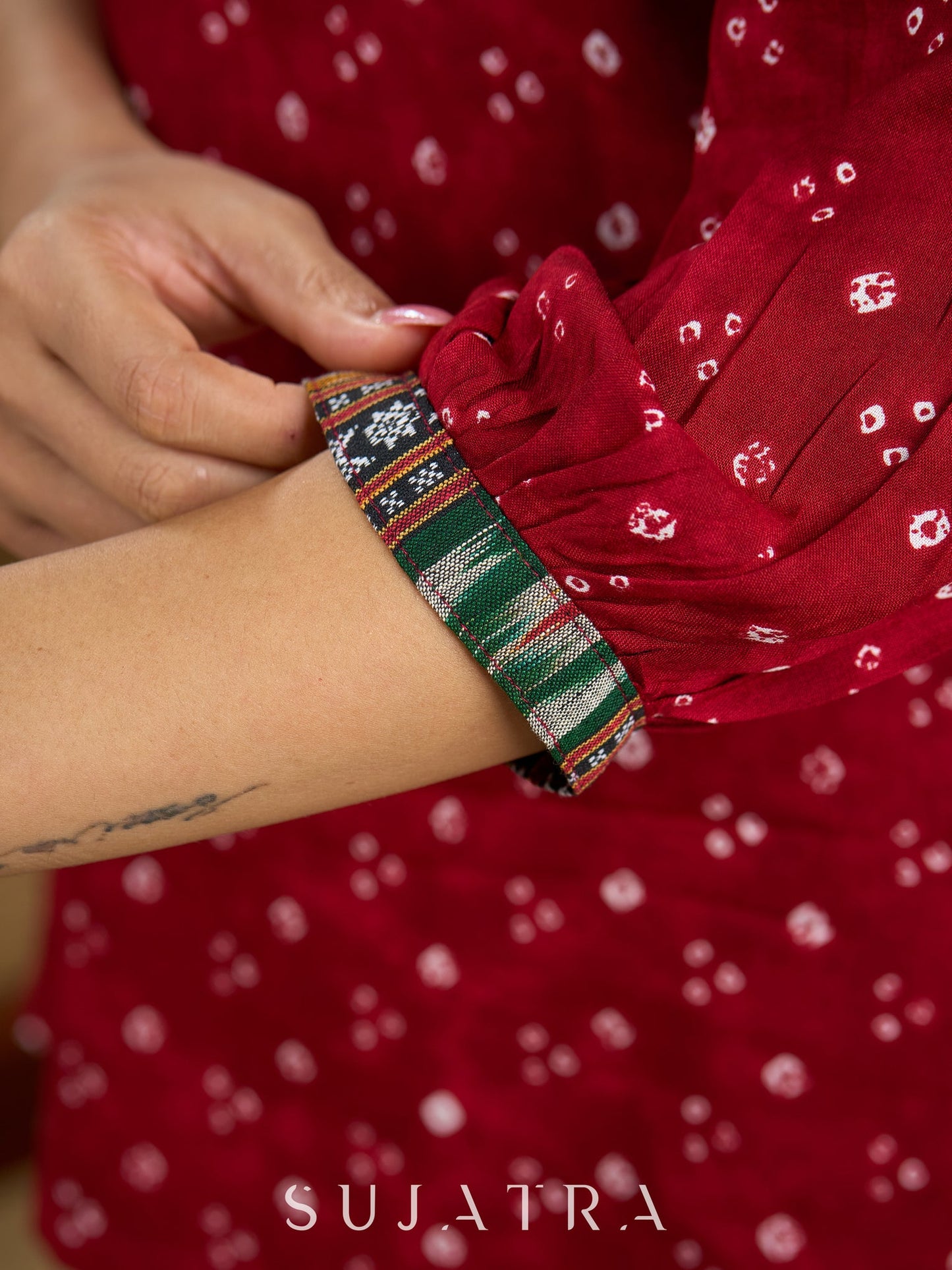 Red rayon bandhani top beautifully combined with classic ikat collar.