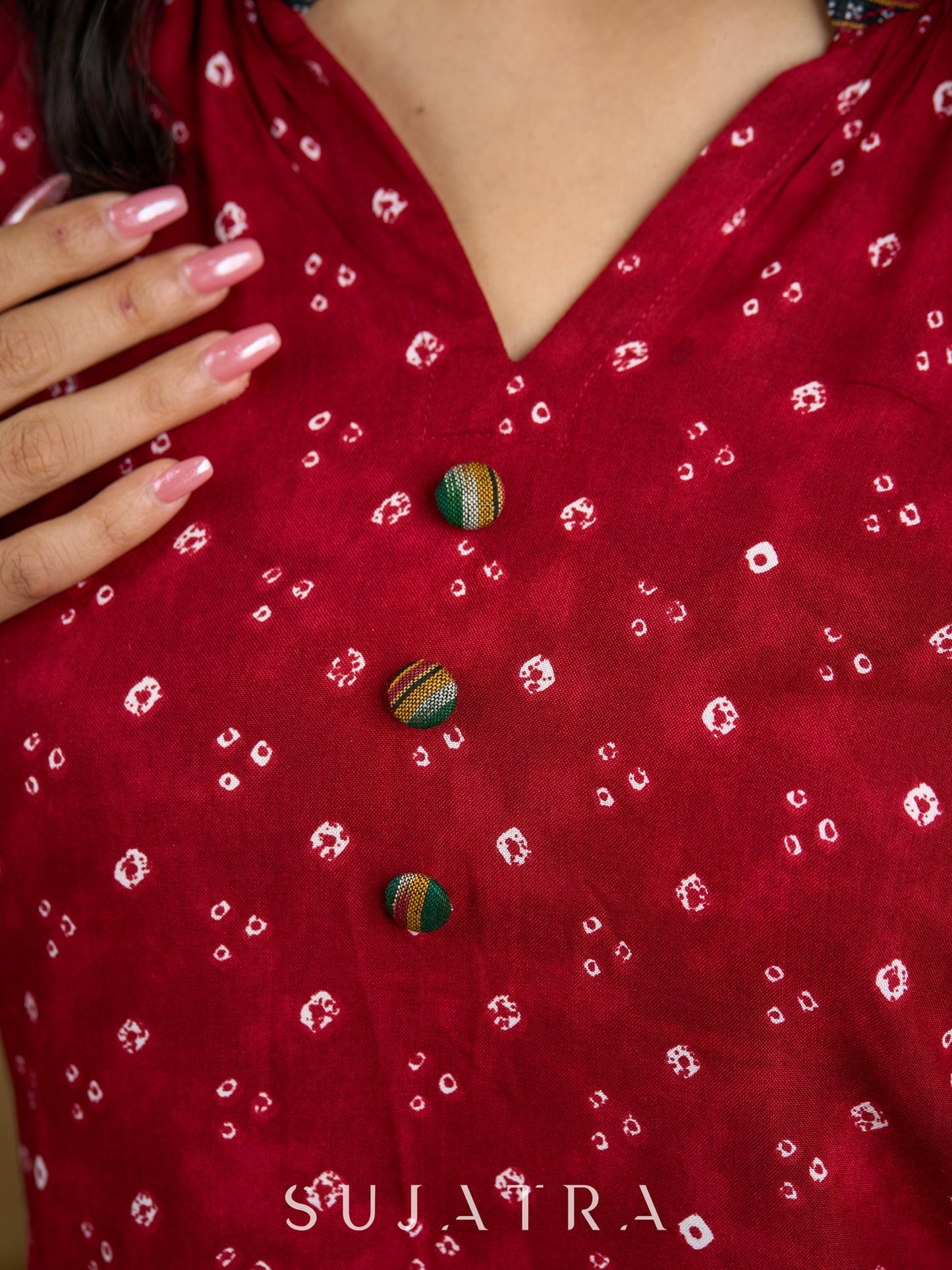 Red rayon bandhani top beautifully combined with classic ikat collar.