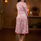 Elegant white floral Jaipuri printed dress with a delicately pintucked red panel, gathered sleeves, and rich red accents.