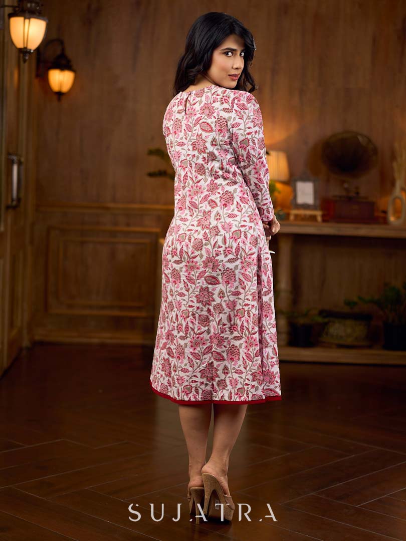 Elegant white floral Jaipuri printed dress with a delicately pintucked red panel, gathered sleeves, and rich red accents.
