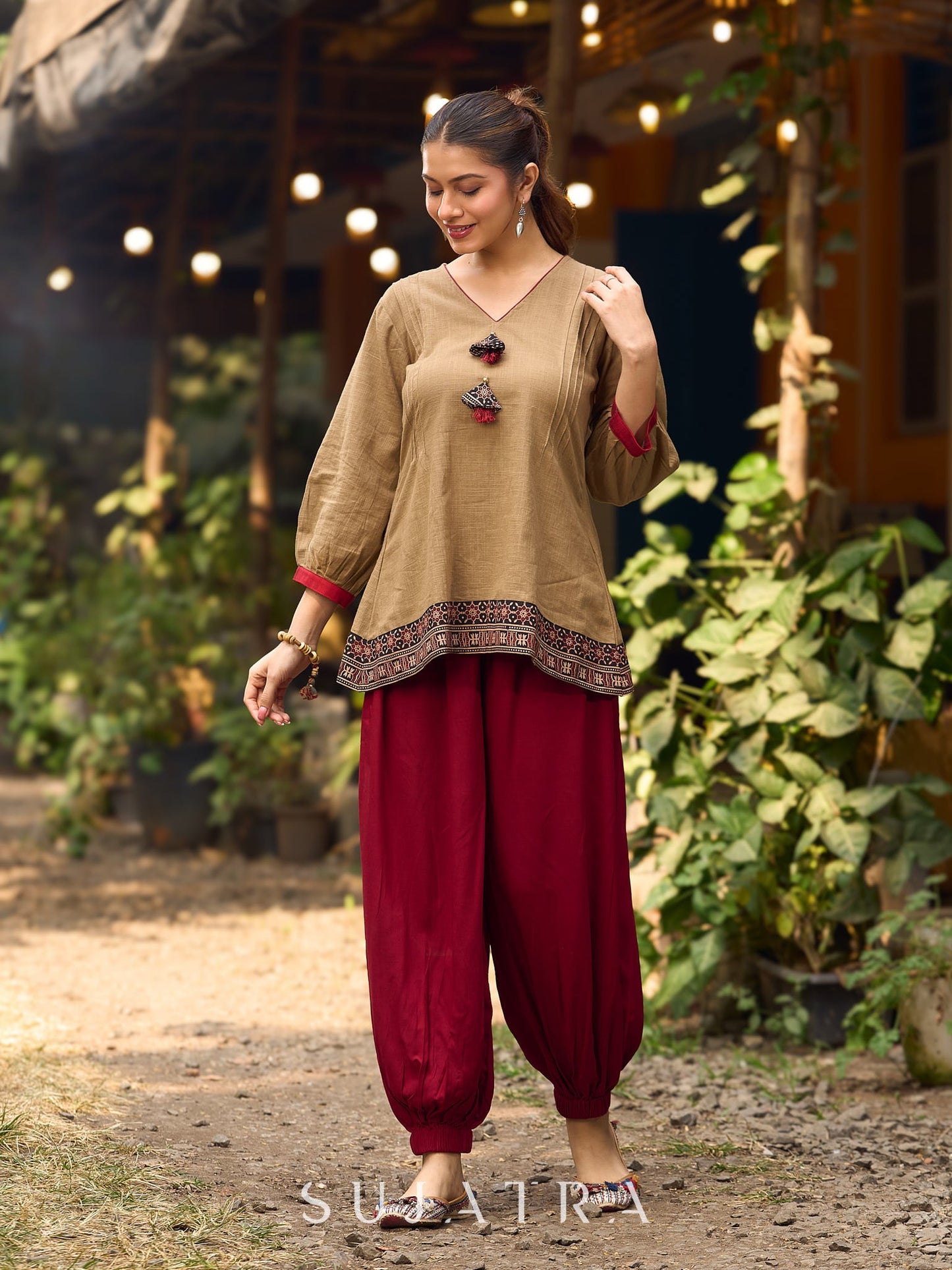 Beige Cotton Top Featuring Ajrakh Border, V Neckline, Gathered Sleeves And Fabric Tassels
