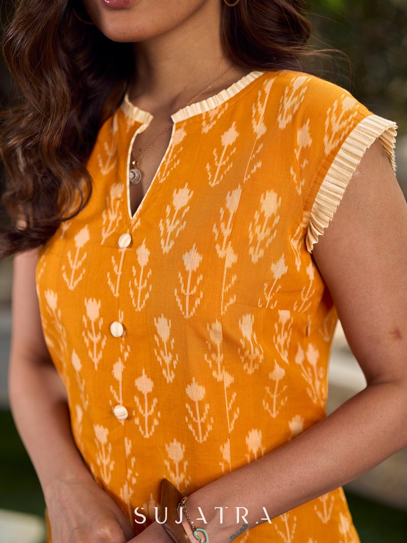 Statement mercerised mustard Ikat dress elevated with drop-shoulder styling, pleated neckline and sleeves detailing featuring soft box pleats for ease and movement