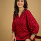 Red rayon bandhani top beautifully combined with classic ikat collar.