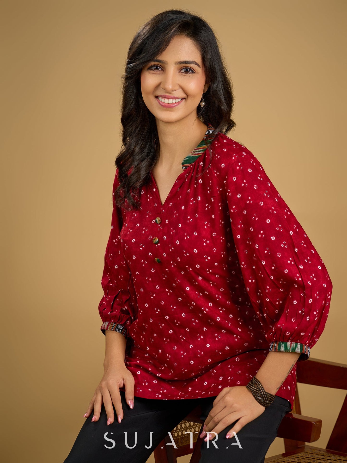 Red rayon bandhani top beautifully combined with classic ikat collar.