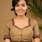 Exquisite hand embroidered dark beige ajrakh combination cotton blouse.