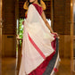 Striking white cotton saree with bold red-black borders, featuring a hand-painted Durga motif