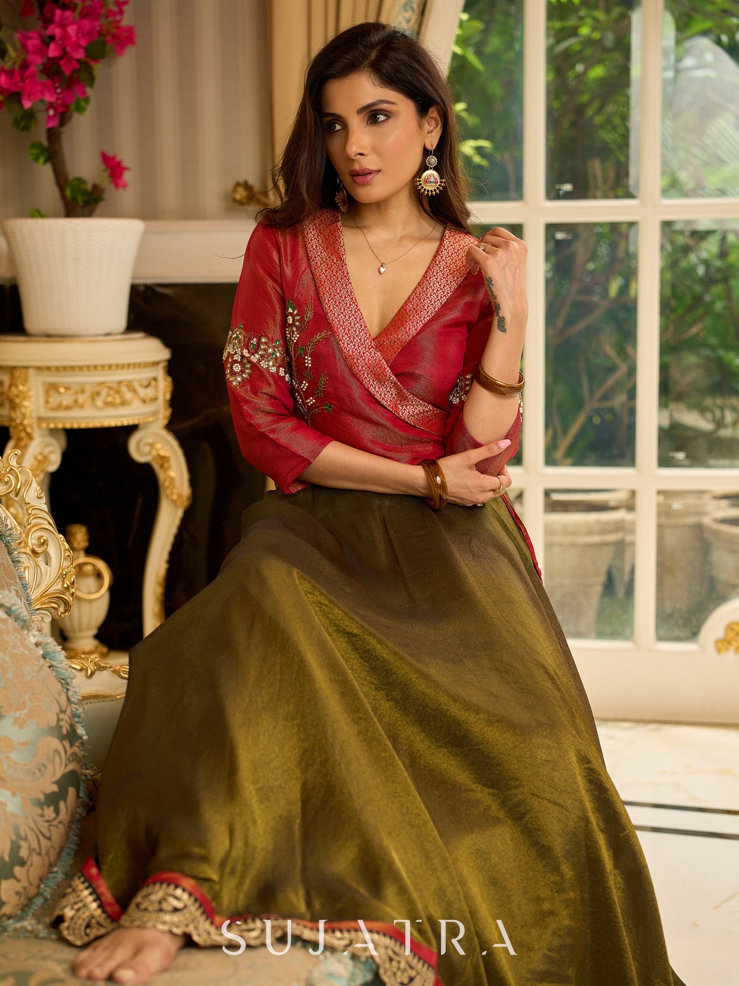 Luminous Green tissue lehenga with a classic Red Angrakha choli featuring intricate hand embroidery.