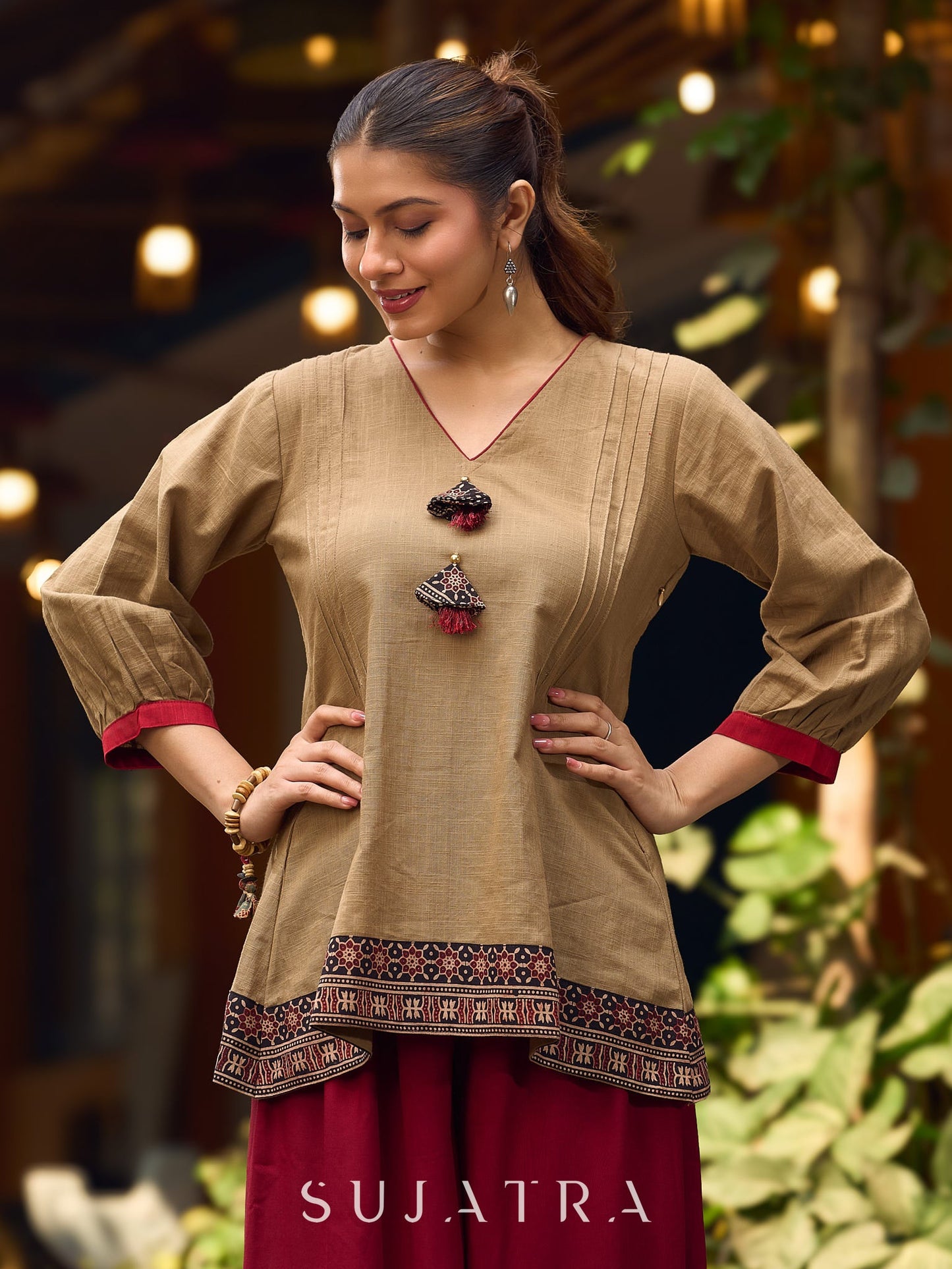 Beige Cotton Top Featuring Ajrakh Border, V Neckline, Gathered Sleeves And Fabric Tassels