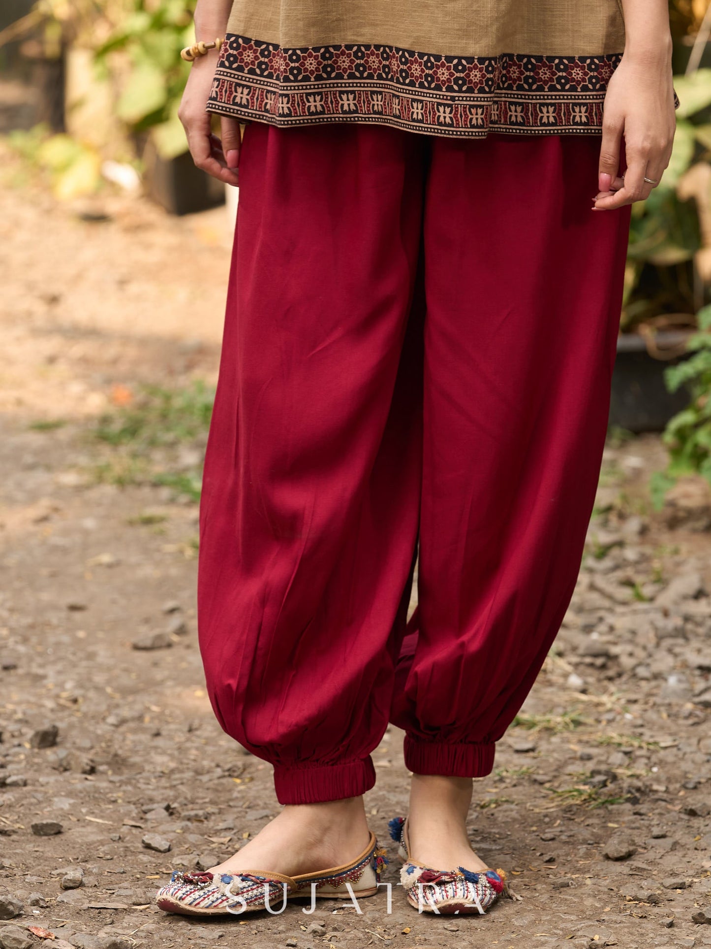 Beige Cotton Top Featuring Ajrakh Border, V Neckline, Gathered Sleeves And Fabric Tassels