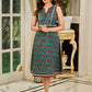 Flowy Green Floral Printed Cotton Dress with Flared Silhouette, Maroon Contrast Trims, and Crochet Lace Edges