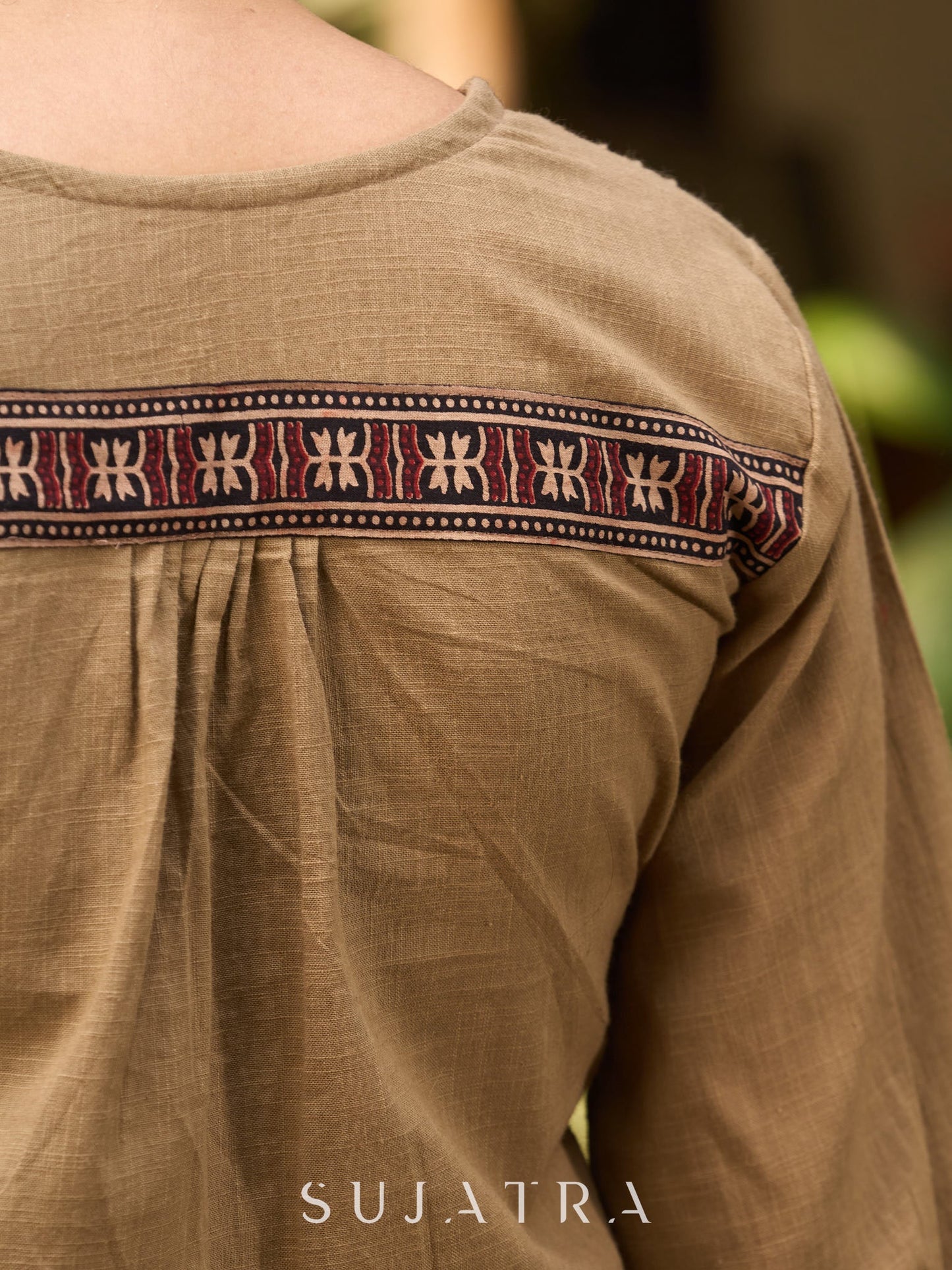 Beige Cotton Top Featuring Ajrakh Border, V Neckline, Gathered Sleeves And Fabric Tassels